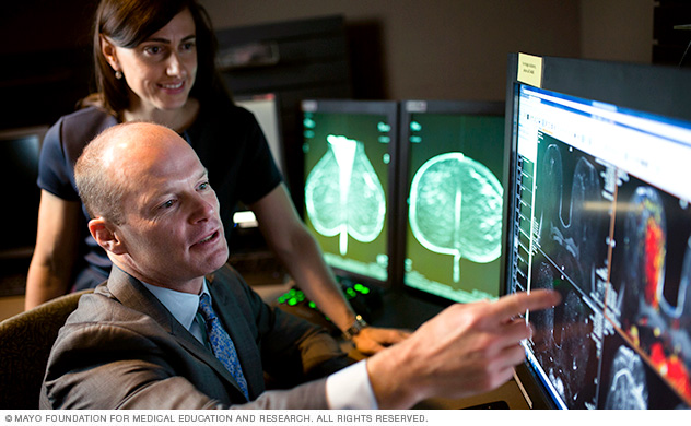 A surgeon discussing a case with a colleague