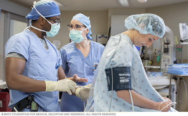 Anesthesiology specialists consult for a patient epidural.