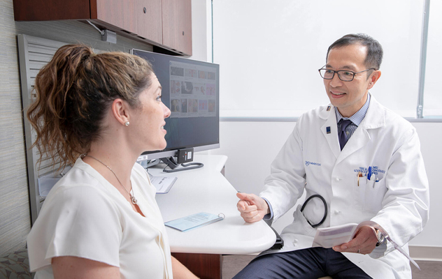 A gynecologist talks with a patient.