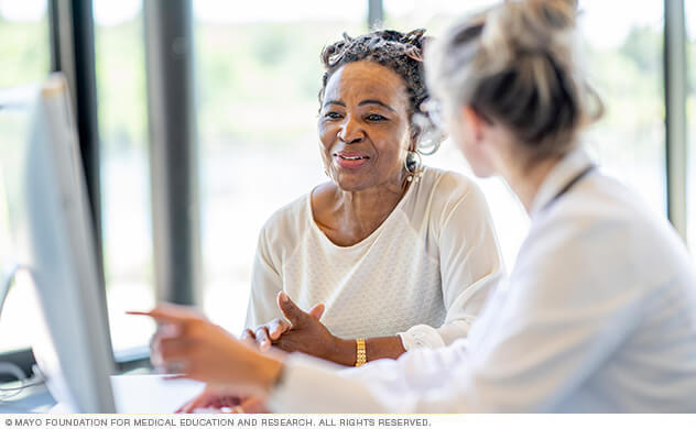 A woman reviews results with her doctor